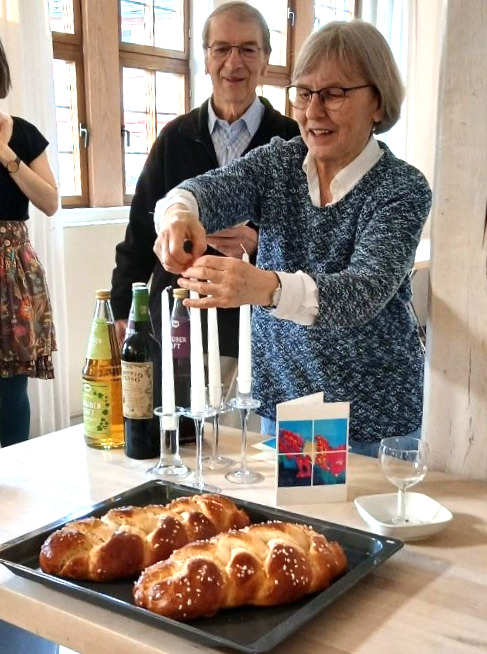  Eine Frau entzündet Kerzen